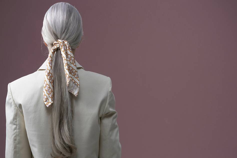 A collection of stylish hair bands in various colors and designs on a soft pastel background