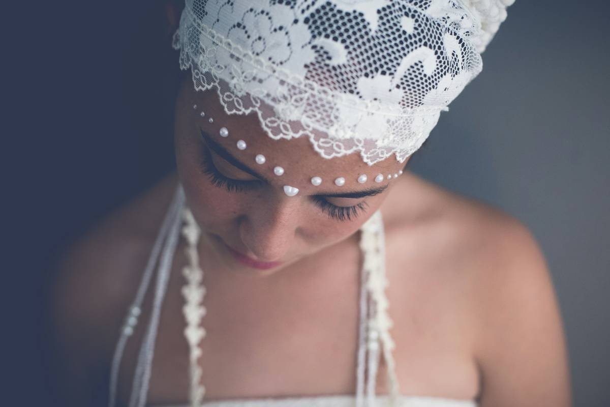 Bride wearing lace hair bands in an intricate updo